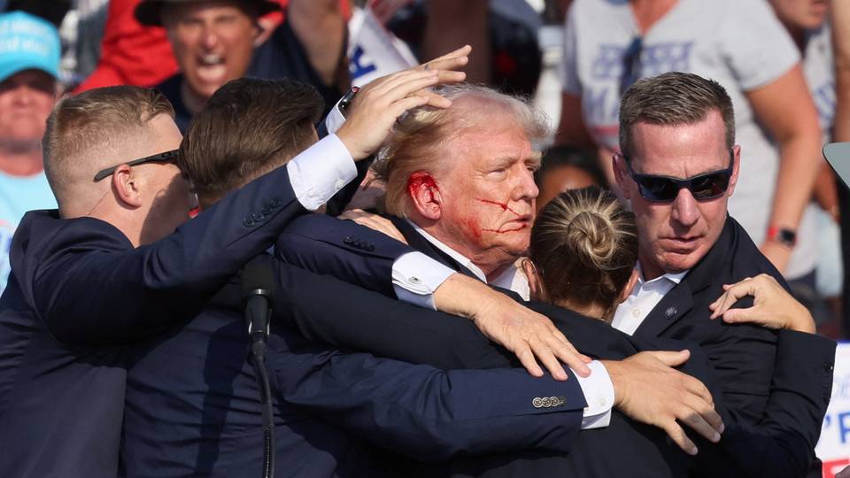 Trump evacuated from rally stage after apparent shots heard