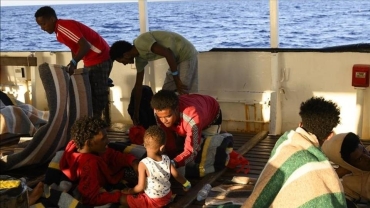 Italian coast guards rescue dozens of migrants from sinking boat