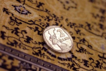 South African rand holds steady as investors await watchdog verdict