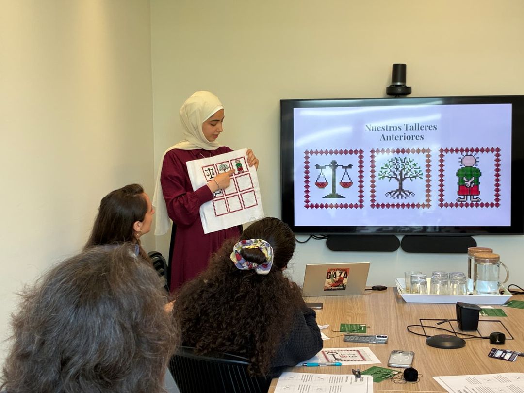 Dalia Kayed survived the genocide. She now tells her story through photos and embroidery.